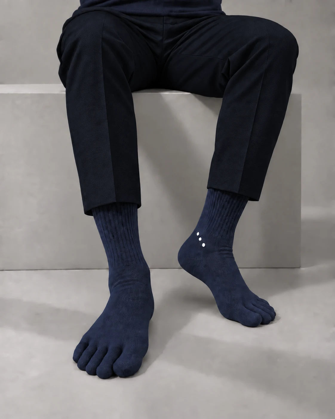 Navy Elegant merino toe socks worn with tailored trousers.